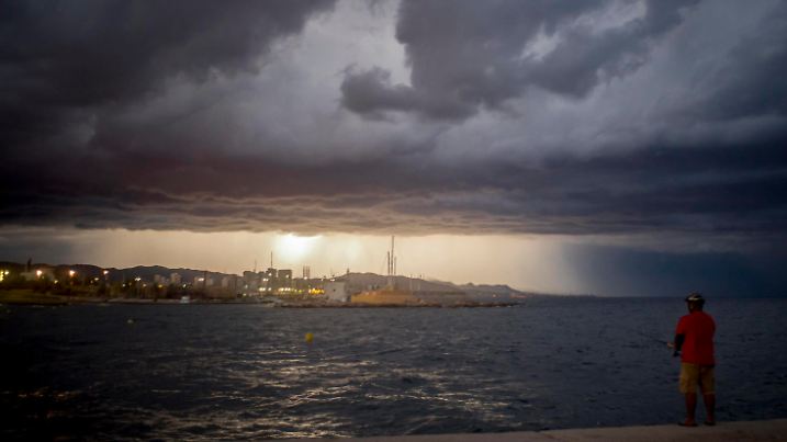 August 30, 2020, Barcelona, Catalonia, Spain: On this Sunday evening, a man fishes from a Barcelona breakwater as a thunderstorm looms on the horizon. Barcelona Spain - ZUMAb137 20200830_zap_b137_006 Copyright: xJordixBoixareux