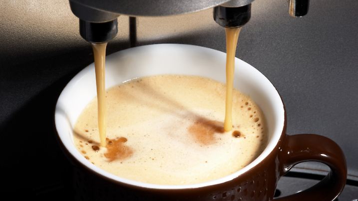 coffe dispenser with cup of coffee