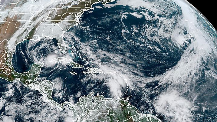 This Tuesday, Nov. 10, 2020, satellite image made available by NOAA shows Tropical Storm Eta at 10:40 a.m. EST in the Gulf of Mexico, Theta, right, and a tropical wave to the south that forecasters say has a good chance of becoming Tropical Storm Iota. (NOAA via AP)