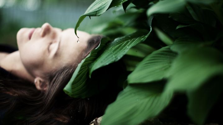 Young woman sleeping, focus on the leaves
