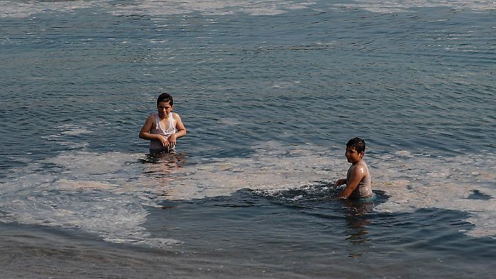 Children play on sea at the Caddebostan shore, in Asian side of Istanbul, Monday, June 7, 2021, covered with marine mucilage, a thick, slimy substance made up of compounds released by marine organisms, in Turkey's Marmara Sea. Turkey's President Recep Tayyip Erdogan promised Saturday to rescue the Marmara Sea from an outbreak of "sea snot" that is alarming marine biologists and environmentalists.(AP Photo/Kemal Aslan)
