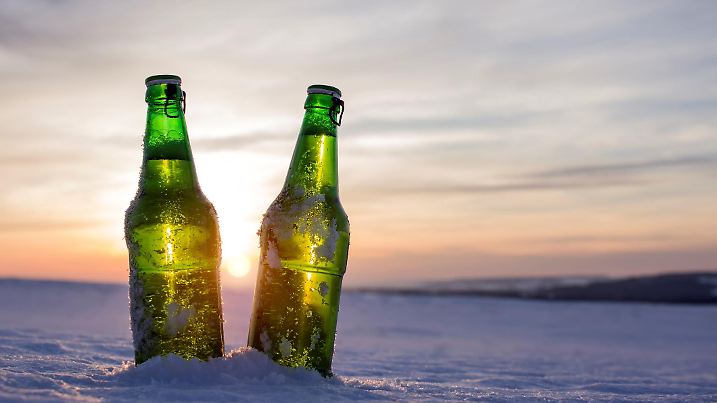 Two bottles of cold beer at sunset