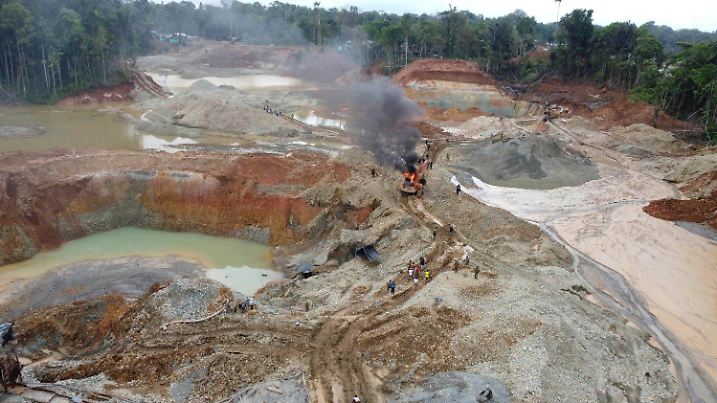 20.04.2021, Kolumbien, Magui Payan: Polizisten gehen gegen eine illegale Goldmine vor, während Soldaten als Teil der «Operation Guamuez III» Wache stehen. Illegaler Goldabbau wird in Gebieten betrieben, die von kriminellen Banden mit wenig staatlicher Präsenz beherrscht werden. Foto: Fernando Vergara/AP/dpa +++ dpa-Bildfunk +++