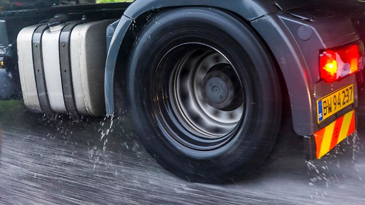 Zealand, Denmark - July 8, 2012: A truck driving at high speed is going through heavy rain. The water splashes from the tires.