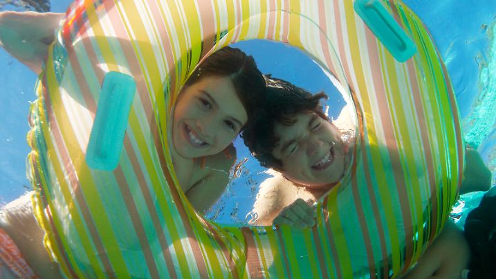 Happy Brother And Sister Looking Through Inflatable Ring, model released, , 10041678.jpg, outdoors, day, eye contact, eyes closed, smiling, peeking, child, boy, girl, two people, swimwear, swimming pool, underwater, recreation, friendship, fun, inflatable raft, circle, leisure, striped, Whites, inflatable, water, ring, swimming, pool,