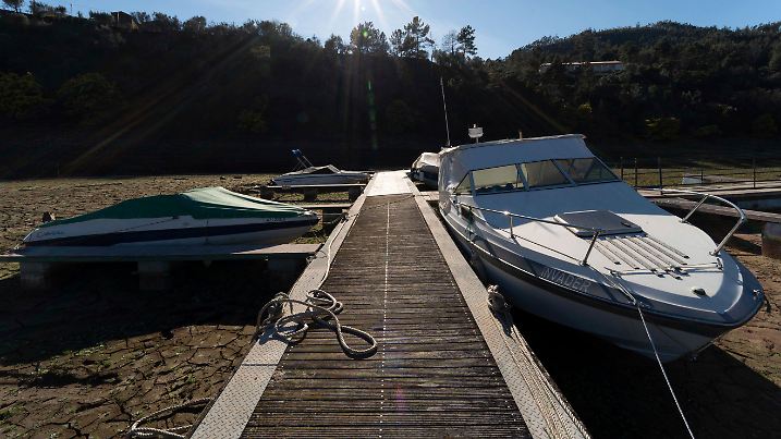 Pleasure boats tied to a pier rest on dry ground of the water depleted Zezere River due to drought, near Figueiro dos Vinhos in central Portugal, Thursday, Feb. 17, 2022. Portugal has seen little rain since last October. By the end of January, 45% of the country was enduring "severe" or "extreme" drought conditions, according to the national weather agency IPMA. (AP Photo/Sergio Azenha)