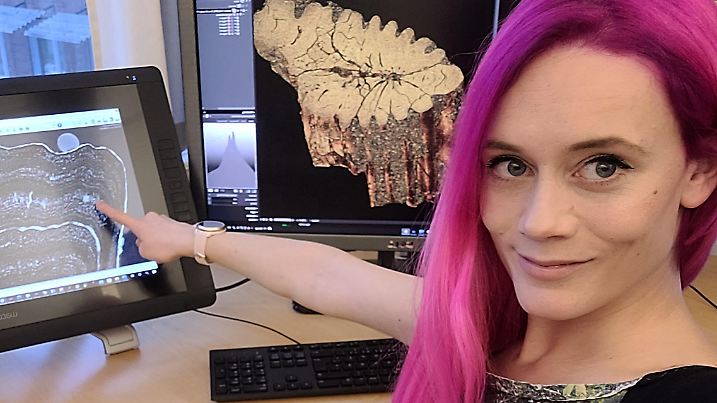A handout photo shows Melanie During, a doctoral student in paleontology at the Uppsala University in Sweden, in her office at the university, pointing at an image of a Cretaceous Period paddlefish fossil that bears evidence of the aftermath of the Yucatan asteroid impact 66 million years ago that caused one of Earth's worst mass extinctions of species, in this handout picture taken on February 17, 2022. Picture taken February 17, 2022. Courtesy of Melanie During/Handout via REUTERS THIS IMAGE HAS BEEN SUPPLIED BY A THIRD PARTY. MANDATORY CREDIT. NO RESALES. NO ARCHIVES.