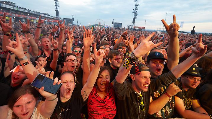 Rockfans jubeln vor der Hauptbühne des Open-Air-Festivals "Rock am Ring" während des Auftritts der Rockband "Tenacious D". An drei Tagen treten hier über 70 Bands auf drei Bühnen auf.