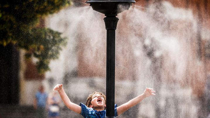 July 4, 2022, Krakow, Poland: A boy is cooling down at a water sprinkler at the Podgorski Square as heat wave continues. Hot air masses from over Africa covered most of the country. (Credit Image: Â© Beata Zawrzel/ZUMA Press Wire