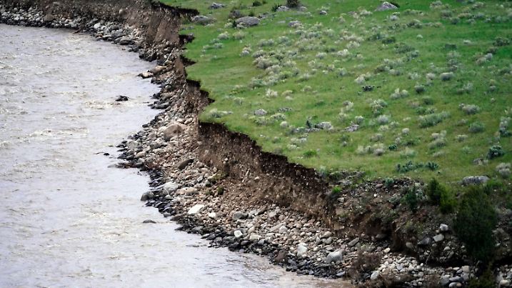 The Yellowstone River flows through an eroded shoreline Wednesday, June 15, 2022, near Gardiner, Mont. Yellowstone National Park officials say more than 10,000 visitors have been ordered out of the nation's oldest national park after unprecedented flooding tore through its northern half, washing out bridges and roads and sweeping an employee bunkhouse miles downstream. (AP Photo/Rick Bowmer)