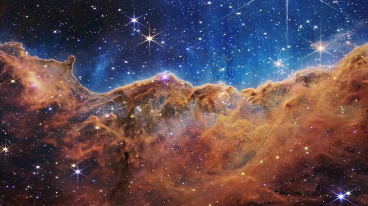 (220712) -- GREENBELT (U.S.), July 12, 2022 (Xinhua) -- Image released by NASA on July 12, 2022 shows the edge of a nearby, young, star-forming region called NGC 3324 in the Carina Nebula. Captured in infrared light by NASA's James Webb Space Telescope, the image reveals for the first time previously invisible areas of star birth. NASA released James Webb Space Telescope's first full-color images of the universe and their spectroscopic data on Tuesday, revealing the unprecedented and detailed views of the universe. (NASA, ESA, CSA, STScI/Handout via Xinhua)