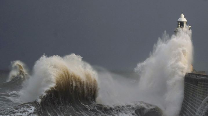 Huge waves crash over Tynemouth pier on the North East coast of England, Thursday, Dec. 8, 2022. (Owen Humphreys/PA via AP)