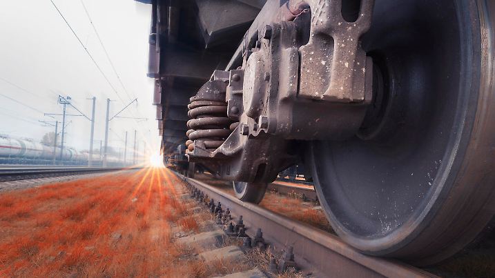 Bottom View of the wheels of a train traveling fast by rail. Fast cargo delivery by train. Blurred background gives a motion effect.
