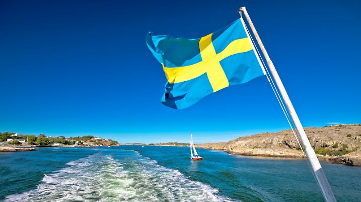 Swedish flag on the boat in Gothenburg islands archipelago, Vastra Gotaland County, Sweden
