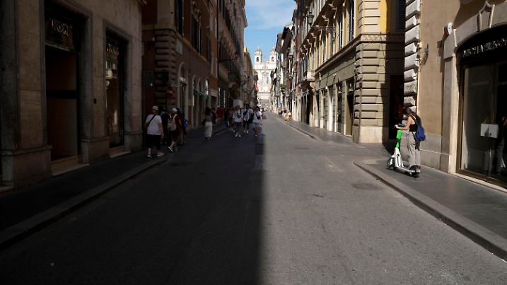 People walk on the shaded part of a street in downtown Rome, Saturday, July 22, 2023. An intense heat wave has reached Italy, bringing temperatures close to 40 degrees Celsius in many cities across the country. (AP Photo/Andrew Medichini)