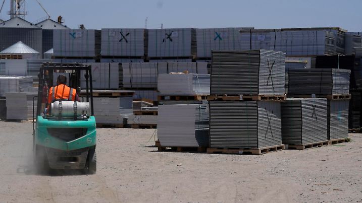 A worker drives a fork lift near rows of used solar panels as they begin the recycling process at We Recycle Solar on Tuesday, June 6, 2023, in Yuma, Ariz. North America’s first utility-scale solar panel recycling plant opened to address what founders of the company call a “tsunami” of solar waste, as technology that became popular in the early 2000s rapidly scales up.  (AP Photo/Gregory Bull)