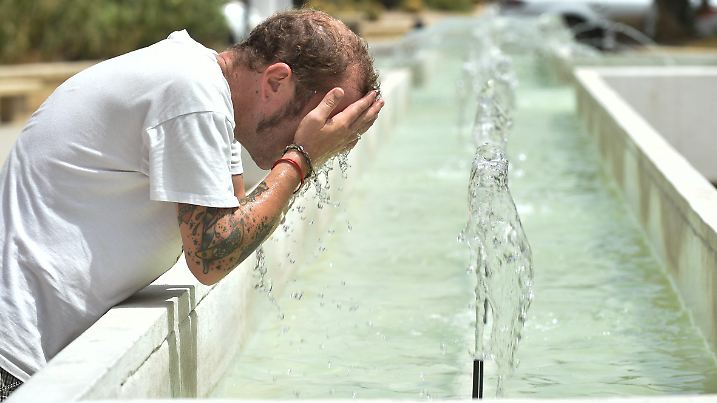 10.08.2023, Spanien, Murcia: Ein Mann kühlt sich in einem Brunnen in Murcia ab. Die staatliche meteorologische Agentur AEMET hat für mehrere Gebiete des Landes die Alarmstufe Rot wegen hoher Temperaturen ausgerufen. Die Temperaturen könnten zwischen 42 und 44 Grad Celsius erreichen. Foto: Javier Carrión/EUROPA PRESS/dpa +++ dpa-Bildfunk +++