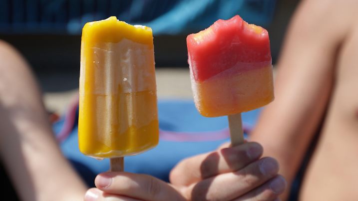 ARCHIV - 11.06.2023, Nordrhein-Westfalen, Köln: Eis am Stiel hält ein Paar bei sommerlich warmen Temperaturen in einem Schwimmbad. (zu dpa "Streit vor 100 Jahren: Wer steckte zuerst den Stiel ins Eis?" - Wiederholung vom 02.10.2023) Foto: David Young/dpa +++ dpa-Bildfunk +++