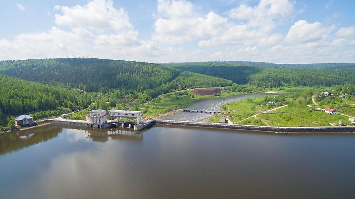 Panorama of spillway on old hydroelectric power station in sunny day aerial view