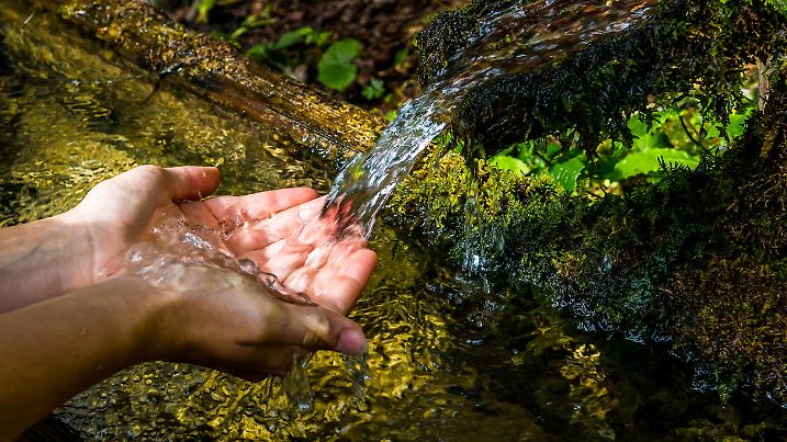 Washing Hands And Drink From A Spring With Clear And Cold Mountain Water