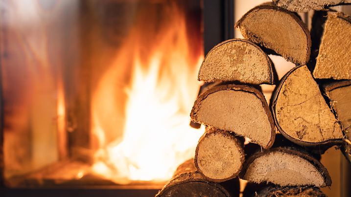 Firewood stack in front of stove.