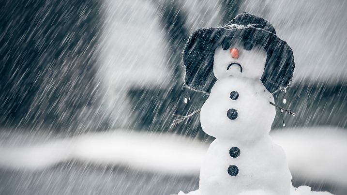 Melting snowman on the warm rainy day in the middle of January winter weather anomalies.