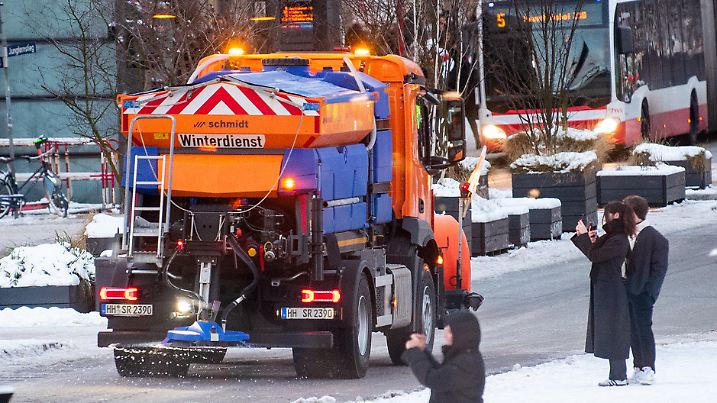 07.01.2024, Hamburg: Ein Fahrzeug vom Winterdienst fährt in der Innenstadt über den Jungfernstieg und streut die Straße. (zu dpa "Plötzliche Glätte löst im Norden zahlreiche Unfälle aus") Foto: Daniel Bockwoldt/dpa +++ dpa-Bildfunk +++