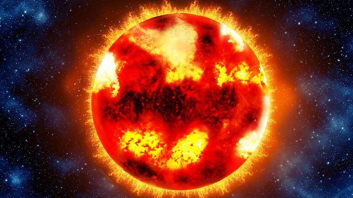 Bright and hot orange sun on a black space background