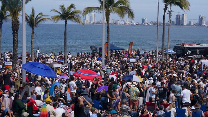 People watch a total solar eclipse in Mazatlan, Mexico, Monday, April 8, 2023. (AP Photo/Fernando Llano)