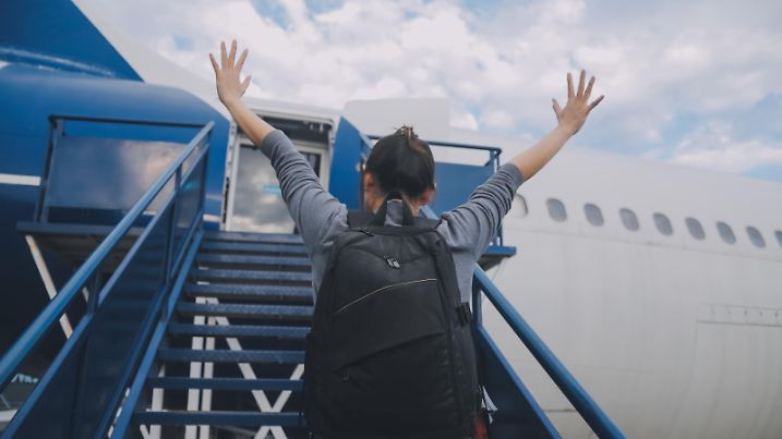 Happy attractive asian woman traveler with backpack at the modern airport terminal, copy space, Tourist journey trip concept