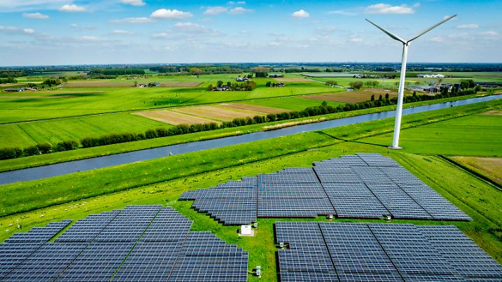 WAALWIJk - Drone photo of a solar park with solar panels and wind turbines from eneco are in the landscape in nature with electricity pylons in the foreground / 230424