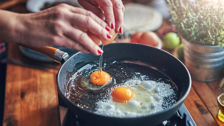 Frying Egg in a Cooking Pan in Domestic Kitchen