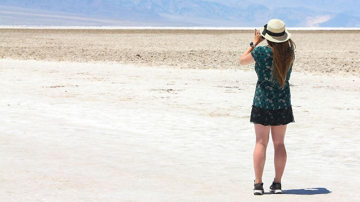 July 7, 2024, Death Valley, California, United States: A person takes a photo on the salt flats at Badwater Basin in Death Valley National Park. (Credit Image: © Gabe Ginsberg/SOPA Images via ZUMA Press Wire) / action press