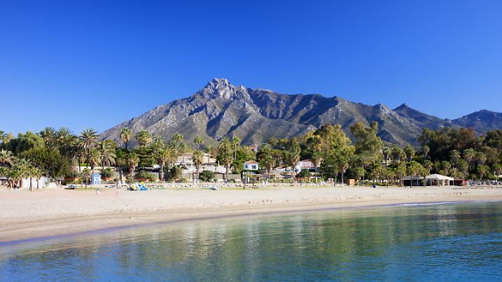Marbella sandy beach, summer holiday scenery by the Mediterranean Sea in Spain, Andalusia region, Costa del Sol, Malaga province.