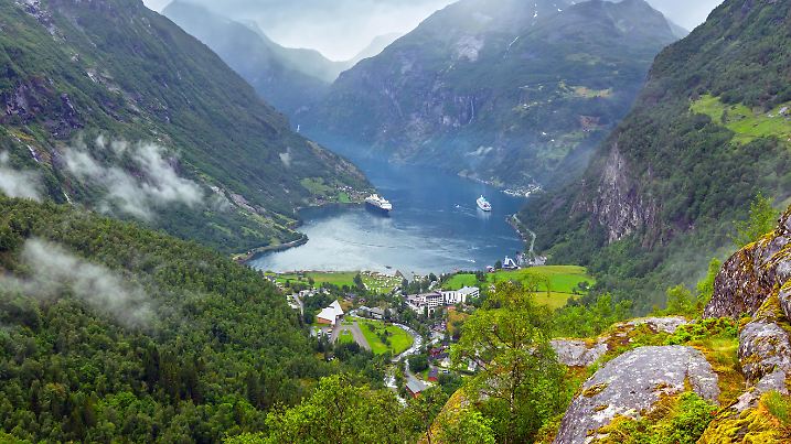 Geiranger Fjord cloudy summer panorama from above Dalsnibba mount, Norway.
