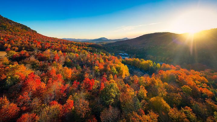 Aerial view of Mountain Forests with Brilliant Fall Colors in Autumn at Sunrise, Adirondacks, New York, New England