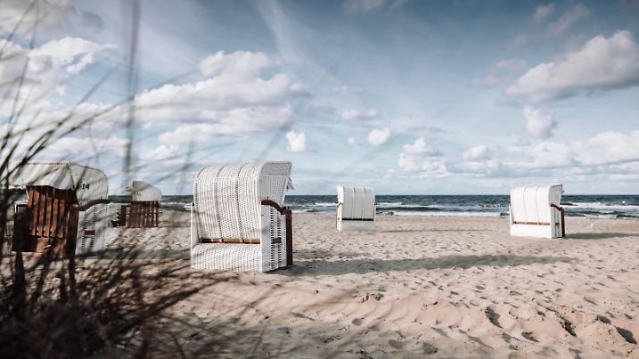 Serene beach scene with traditional beach chairs at Sehlendorfer Strand, Germany.