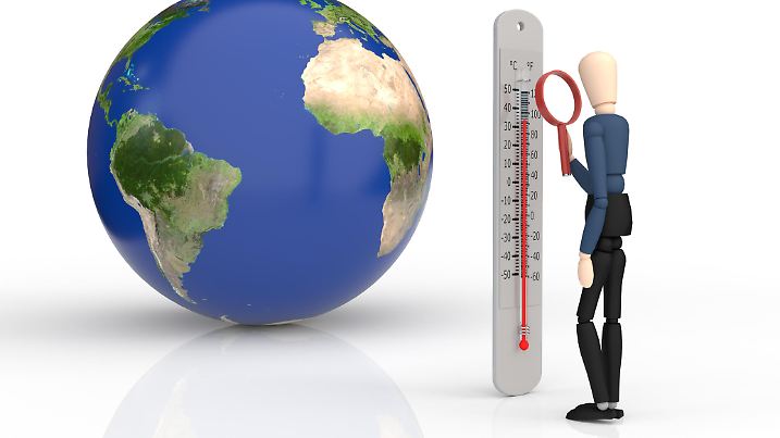 Earth and wooden puppet looking at a thermometer with a magnifying glass. Rising temperatures, global warming concept