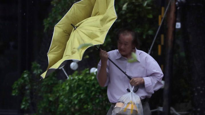 A man struggles with his umbrella against gusts of wind generated by Typhoon Kong-rey in Taipei, Taiwan, Thursday, Oct. 31, 2024. (AP Photo/Chiang Ying-ying)