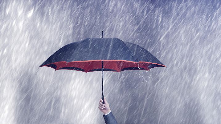businessman holding umbrella on a rainy day