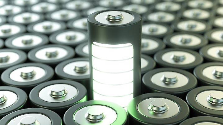 Green battery surrounded by other batteries.