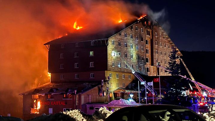 Firefighters work to extinguish a fire in a hotel at a ski resort of Kartalkaya in Bolu province, in northwest Turkey, Tuesday, Jan. 21, 2025. (IHA via AP)