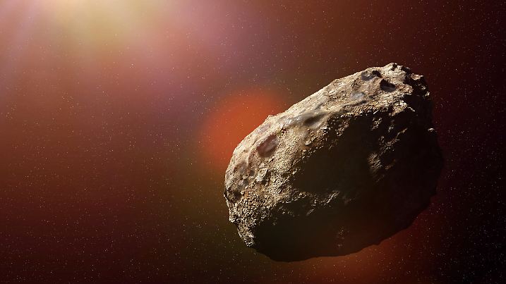 asteroid in deep space lit by a star