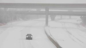 A vehicle travels westbound in blizzard conditions during a winter storm on Interstate 70 in Topeka, Kansas, U.S. January 5, 2025. Evert Nelson/The Capital-Journal/USA Today Network via REUTERS NO RESALES. NO ARCHIVES. MANDATORY CREDIT
