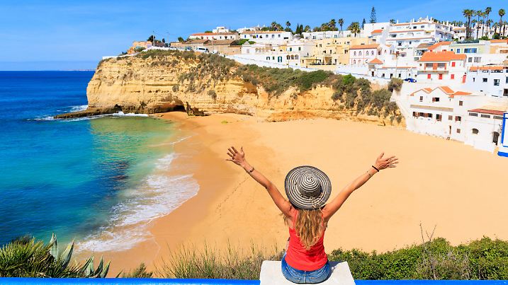Tour tourism in Portugal, atlantic ocean and beautiful tropical beach- woman tourist in Albufeira, Algarve- summer beach vacation concept