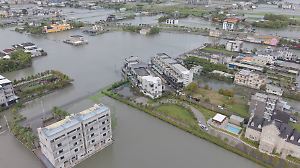 A drone view shows flooded streets and fields in Yilan