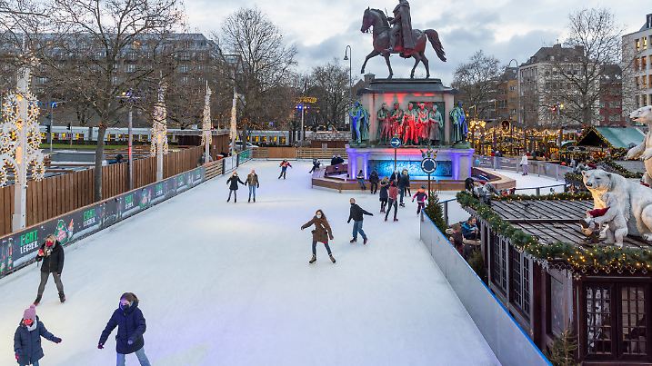 Cologne, Germany - Dec 2nd 2021: Outdoor ice surface attracts people skating in Cologne Christmas market.