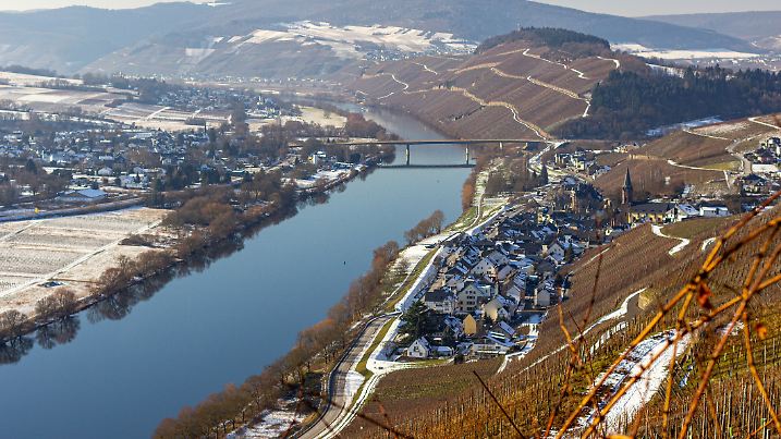 panomamic view on the river Mosel valley and the villages Lieser and Muelheim from a mountain near Bernkastel-Kues in winter with snow