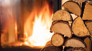 Firewood stack in front of stove.