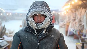 A vendor poses for a picture at a local market on a frosty day in Yakutsk
